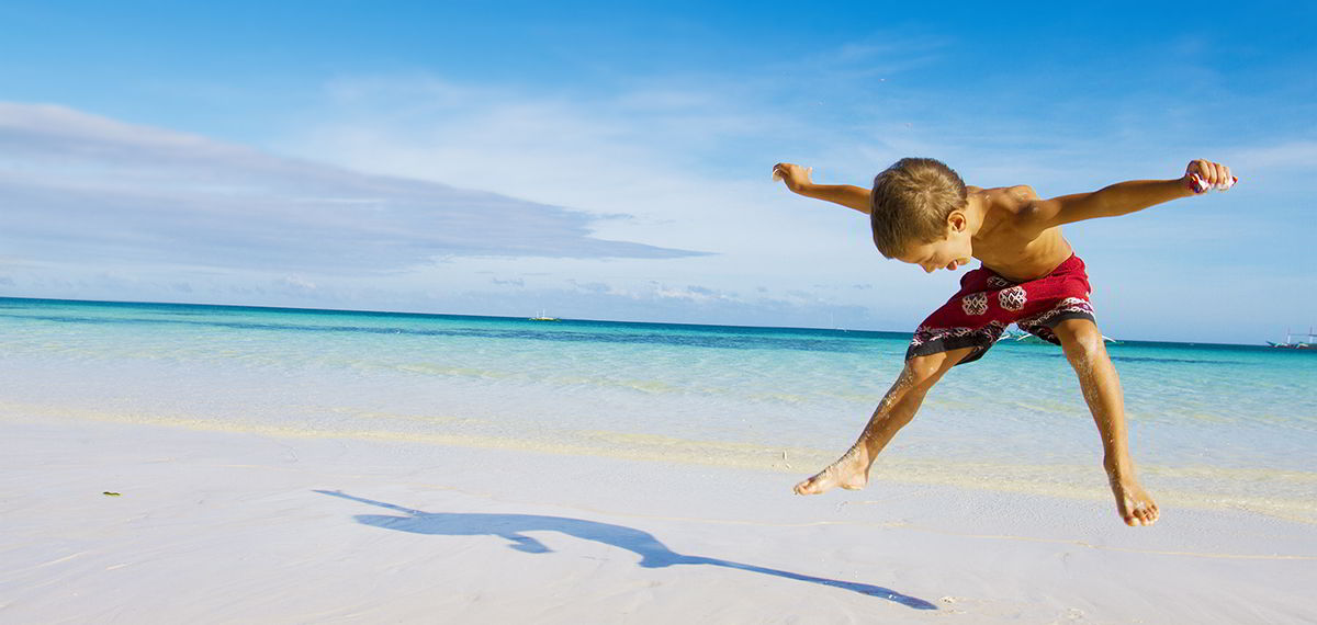 Happy jump on a St. Maarten beach.